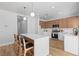Bright kitchen with center island, breakfast bar seating, stainless appliances, and modern cabinetry at 9115 Weeping Hollow Ave, Las Vegas, NV 89178
