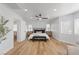 Light-filled main bedroom with a large bed, ceiling fan, and wood floors at 9115 Weeping Hollow Ave, Las Vegas, NV 89178