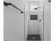 Modern glass shower with a black-tiled floor and accent niche at 9115 Weeping Hollow Ave, Las Vegas, NV 89178