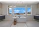 Bright bathroom featuring a soaking tub with neighborhood views at 10718 Desert Heights Ave, Las Vegas, NV 89135