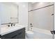 Modern bathroom featuring sleek vanity, bright lighting, and shower over tub combo with neutral tile at 10718 Desert Heights Ave, Las Vegas, NV 89135
