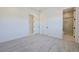 Carpeted bedroom with adjoining full bathroom, neutral color palette, and a bright, inviting space at 10718 Desert Heights Ave, Las Vegas, NV 89135