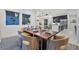 Open-concept dining area features an elegant table setting and seamless flow into the modern kitchen at 10718 Desert Heights Ave, Las Vegas, NV 89135
