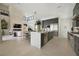 Open-concept kitchen with island seating, modern lighting, and seamless integration with living area at 10718 Desert Heights Ave, Las Vegas, NV 89135