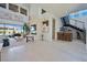 Spacious living room featuring a stylish bar, modern staircase, and expansive windows at 10718 Desert Heights Ave, Las Vegas, NV 89135