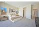 Comfortable main bedroom featuring soft carpet, neutral tones, pendant lighting, and a luxurious king bed at 10718 Desert Heights Ave, Las Vegas, NV 89135
