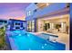 Beautiful backyard featuring a large pool, spa, covered patio, and outdoor living space at 10718 Desert Heights Ave, Las Vegas, NV 89135