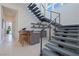 Contemporary staircase next to a stylish wet bar, illuminated by abundant natural light at 10718 Desert Heights Ave, Las Vegas, NV 89135