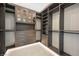 Walk-in closet with custom shelving and modern lighting at 10718 Desert Heights Ave, Las Vegas, NV 89135