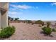 Expansive backyard featuring low-maintenance desert landscaping and scenic views of the surrounding mountains at 11032 Mission Lakes Ave, Las Vegas, NV 89134