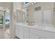Bright bathroom features a double sink vanity with lots of storage and a large mirror at 11032 Mission Lakes Ave, Las Vegas, NV 89134