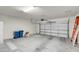 Spacious two-car garage featuring an automatic door, concrete flooring, and ample room for parking and storage at 11032 Mission Lakes Ave, Las Vegas, NV 89134