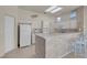 Bright kitchen featuring white cabinets, a bar, and an open design at 11032 Mission Lakes Ave, Las Vegas, NV 89134