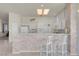 Clean, bright kitchen with bar, white cabinetry, and modern appliances at 11032 Mission Lakes Ave, Las Vegas, NV 89134