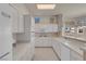 Well-lit white kitchen with modern appliances and convenient breakfast bar at 11032 Mission Lakes Ave, Las Vegas, NV 89134