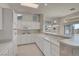 Bright kitchen with all-white features and breakfast bar at 11032 Mission Lakes Ave, Las Vegas, NV 89134