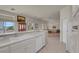 Well-lit kitchen with breakfast bar flowing into the living room at 11032 Mission Lakes Ave, Las Vegas, NV 89134