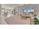 Spacious living room with large windows, ample seating, and a ceiling fan at 11032 Mission Lakes Ave, Las Vegas, NV 89134