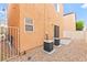 Low-maintenance backyard with two AC units, gravel and fenced perimeter at 11135 Abbeyfield Rose Dr, Henderson, NV 89052