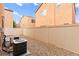 Backyard with a gravel surface, wood fence and patio at 11135 Abbeyfield Rose Dr, Henderson, NV 89052