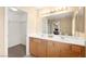 Bathroom vanity featuring double sinks, ample counter space, and neutral decor at 11135 Abbeyfield Rose Dr, Henderson, NV 89052