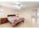 Charming bedroom featuring a ceiling fan, natural light from the window, and neutral color scheme at 11135 Abbeyfield Rose Dr, Henderson, NV 89052