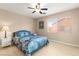 Bedroom featuring a ceiling fan, natural light from the window, and neutral color scheme at 11135 Abbeyfield Rose Dr, Henderson, NV 89052