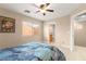 Bedroom featuring a ceiling fan, natural light from the window, and neutral color scheme at 11135 Abbeyfield Rose Dr, Henderson, NV 89052