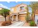 Two-story home with a charming entrance, covered porch, and an attached garage at 11135 Abbeyfield Rose Dr, Henderson, NV 89052