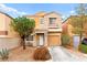 Charming two-story home with a well-maintained front yard and attached garage at 11135 Abbeyfield Rose Dr, Henderson, NV 89052