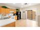 Bright kitchen with stainless steel appliances, tile floors, and access to the patio at 11135 Abbeyfield Rose Dr, Henderson, NV 89052