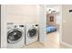 Convenient laundry area with modern washer and dryer, adjacent to bedroom at 11135 Abbeyfield Rose Dr, Henderson, NV 89052
