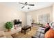 Cozy living room with comfortable seating, tile floors, and ample natural light at 11135 Abbeyfield Rose Dr, Henderson, NV 89052
