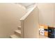 Carpeted stairs that lead to the upper level, with a view of the kitchen at 11135 Abbeyfield Rose Dr, Henderson, NV 89052