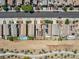 A high angle view reveals a street lined with neat homes, some featuring solar panels and a backyard pool at 1124 Aspen Cliff Dr, Henderson, NV 89011