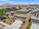 Aerial view of home featuring desert landscaping, a two-car garage and a tile roof at 1124 Aspen Cliff Dr, Henderson, NV 89011