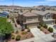 Elevated view of home exterior with desert landscaping and tile roof at 1124 Aspen Cliff Dr, Henderson, NV 89011