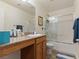 Well-lit bathroom featuring a granite countertop, a shower, and ample storage space at 1124 Aspen Cliff Dr, Henderson, NV 89011