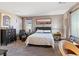 Well-decorated bedroom features a queen bed, a dresser, and ample natural light at 1124 Aspen Cliff Dr, Henderson, NV 89011
