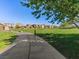 A path through a community park showing a large grassy area, mature trees and residences in the background at 1124 Aspen Cliff Dr, Henderson, NV 89011