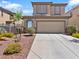 Charming two-story home with a well-maintained front yard and a two-car garage at 1124 Aspen Cliff Dr, Henderson, NV 89011