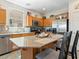 Well-lit kitchen featuring wood cabinets, stainless steel appliances, and a breakfast bar at 1124 Aspen Cliff Dr, Henderson, NV 89011