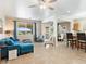 Open-concept living room with tile flooring, ceiling fan, and large windows for natural light at 1124 Aspen Cliff Dr, Henderson, NV 89011