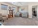 Comfortable living room with neutral decor, ceiling fan and ample natural light at 1124 Aspen Cliff Dr, Henderson, NV 89011