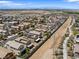 Wide neighborhood view showcasing a residential area with well-maintained homes, desert landscaping and mountain views at 1124 Aspen Cliff Dr, Henderson, NV 89011