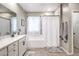 Bathroom features a shower-tub, a large mirror, and decorative window treatments at 1267 Dorado Sea Ct, Henderson, NV 89052
