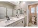 Spacious bathroom with double sinks, white cabinets, and views of the shower at 1267 Dorado Sea Ct, Henderson, NV 89052