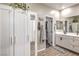 Bathroom with white cabinetry, white and gray decor, with a shower and soaking tub at 1267 Dorado Sea Ct, Henderson, NV 89052