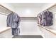Walk-in closet with wood shelving and ample hanging space for organized storage at 1267 Dorado Sea Ct, Henderson, NV 89052
