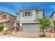 Two-story home showcasing stone accents, neutral paint, an attached two car garage, and desert landscaping at 1267 Dorado Sea Ct, Henderson, NV 89052